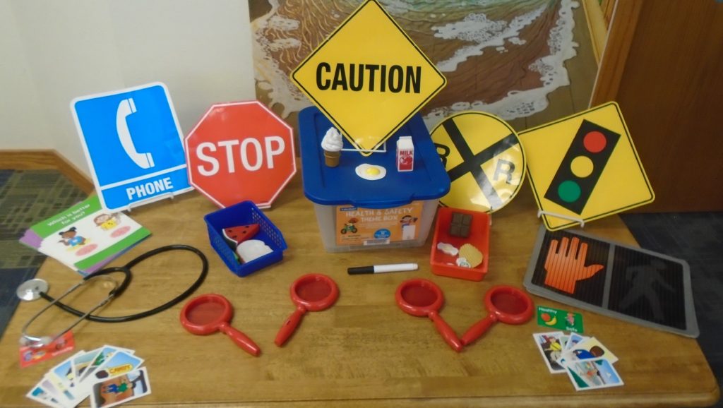 A table with various toy signs and a red handle.