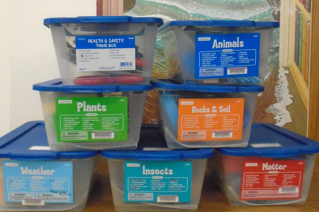A bunch of plastic containers with labels on them